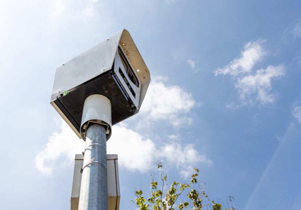 Close-up on speed trap surveillance camera along highway to control speeding to reduce speeding related ccidents.