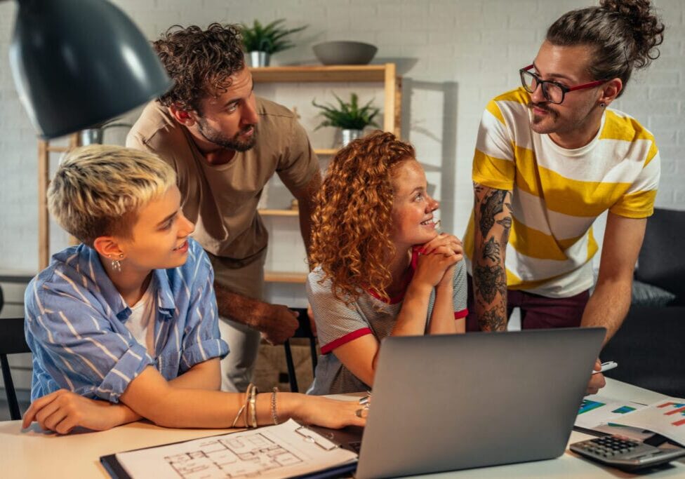 Group of young coworkers working together on new project